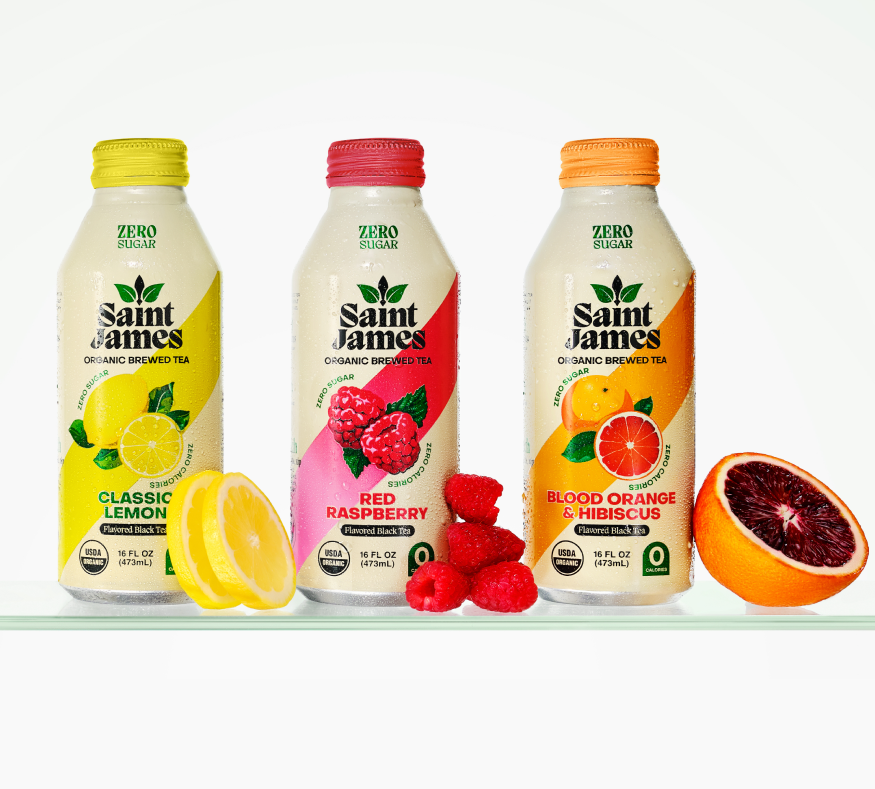 Saint James Classic Lemon, Red Raspberry, and Blood Orange bottles lined up with fruits beside