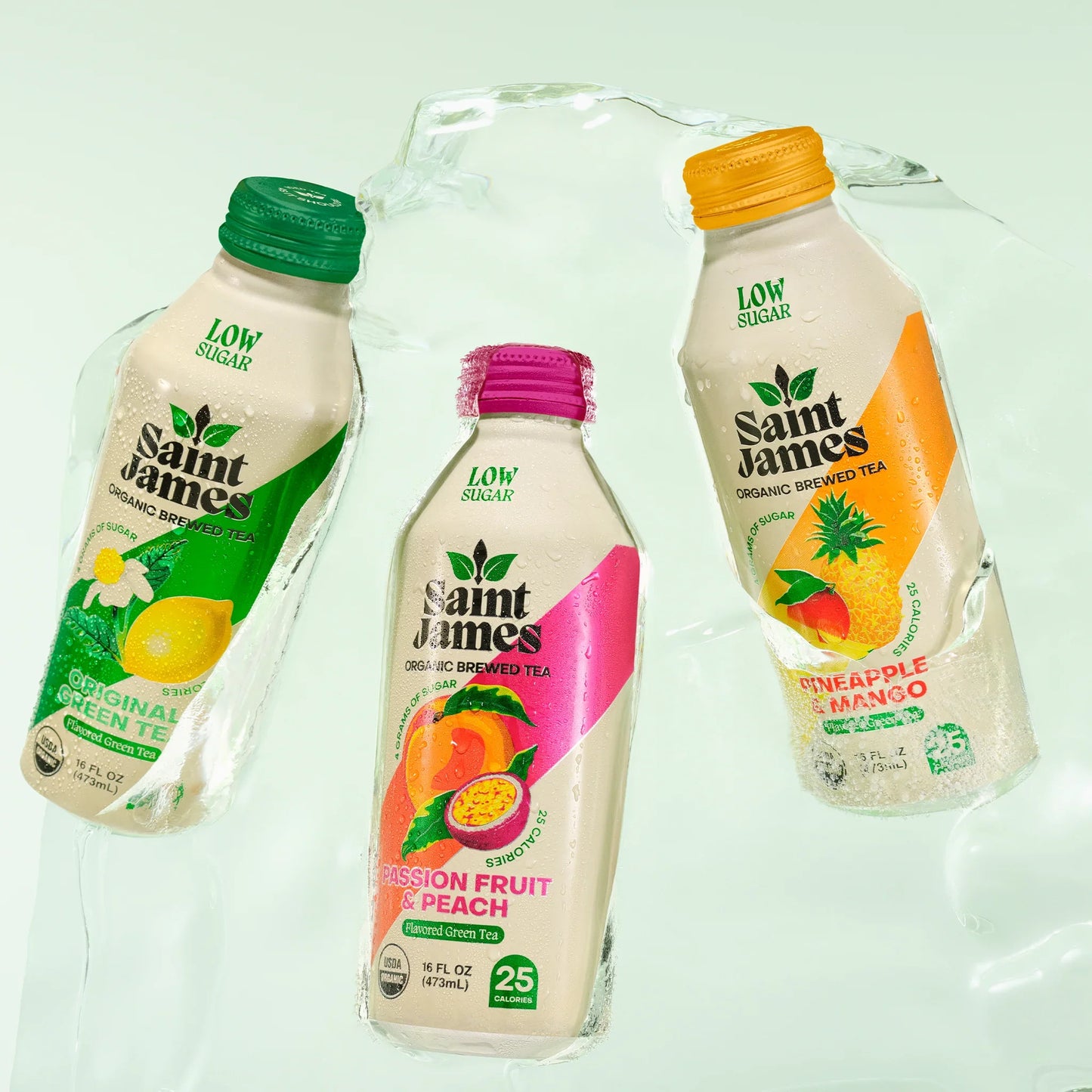 Three bottles of Saint James organic iced tea on a light green background